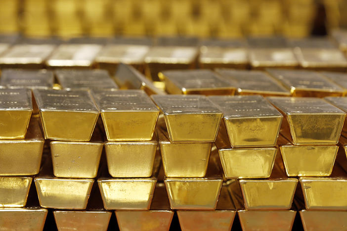 Gold bars are stacked in a vault at the United States Mint, in West Point, N.Y., in 2014. The settlement price for gold futures reached a record high of $1,931 per ounce Monday — and many analysts predict the price will head even higher.