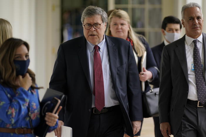 Attorney General William Barr, center, arrives for an event on police reform last month at the White House. Barr is expected to face tough questioning when he appears Tuesday before the House Judiciary Committee.