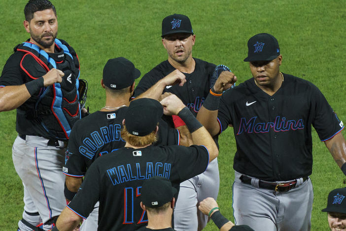 Members of the Miami Marlins celebrate a 5-2 win Friday against the Philadelphia Phillies. The Marlins' home opener Monday against the Baltimore Orioles has been postponed.