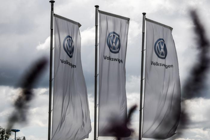 The logo of German automaker Volkswagen appears on flags fluttering in front of a car dealer in Hamm, Germany, in May. One of VW's many legal settlements over the Dieselgate scandal has finally reached its conclusion, the FTC says.