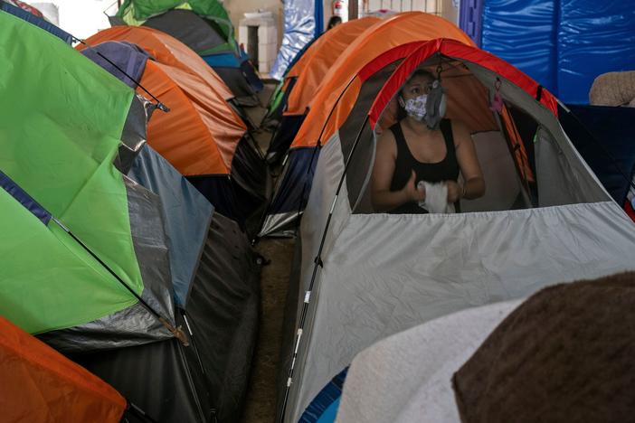 Mexican asylum seeker Eily Sanchez cleans her tent at a migrant shelter in Tijuana, Mexico, last month.