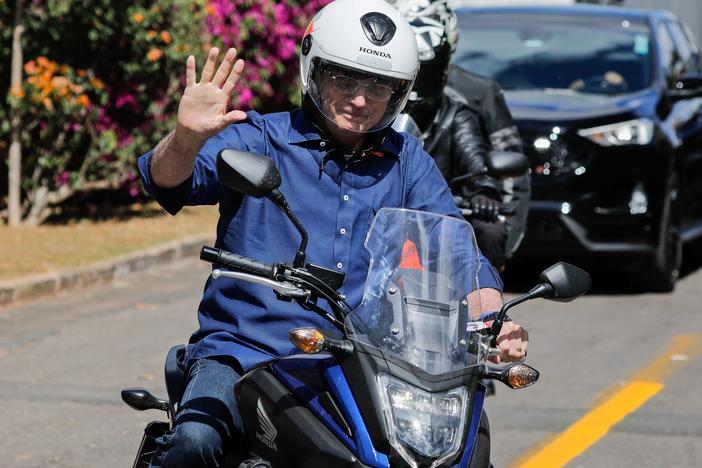 Brazilian President Jair Bolsonaro takes a ride on a motorcycle Saturday in Brasilia after he announced he tested negative for the coronavirus. He had tested positive earlier this month.