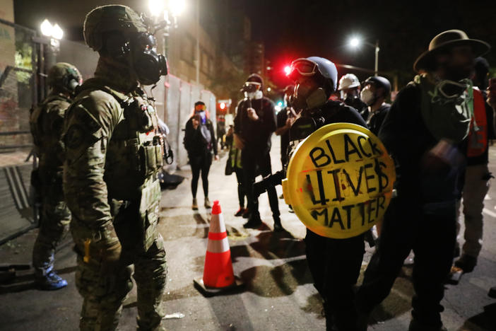 Federal law enforcement agents confront protesters in Portland, Ore., on Sunday.