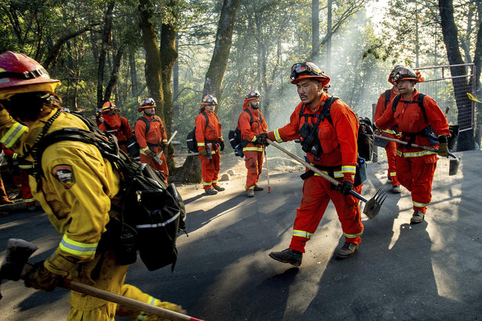 Inmate firefighters battle California's Kincade Fire on Oct. 29, 2019. In late June, officials locked down 12 inmate fire camps after outbreaks of the coronavirus within the state's prison system.