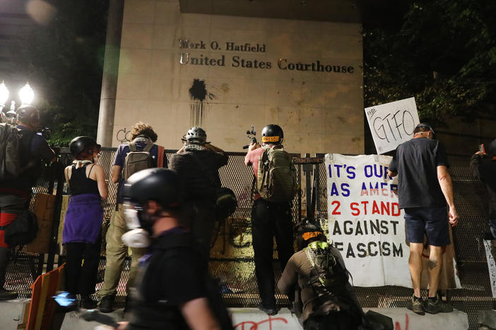 Protesters gather in front of the Mark O. Hatfield federal courthouse in downtown Portland, where some demonstrators have been arrested and others released from jail on the condition that they not attend any more protests.