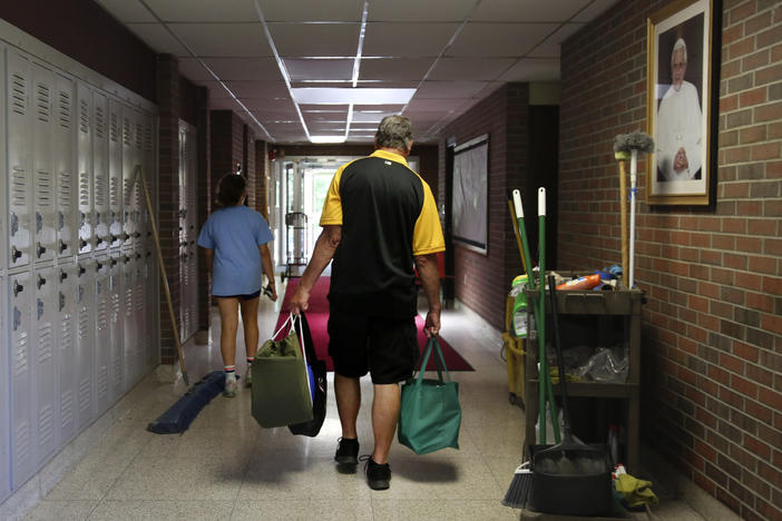 Cesa Pusateri, 12, and her grandfather, Timothy Waxenfelter, principal of Quigley Catholic High School, leave with his collection of speech and debate books after the closure of the school in Baden, Pa., on June 8, 2020. According to the National Catholic Educational Association, at least 100 schools have announced in recent weeks that they won't reopen this fall.
