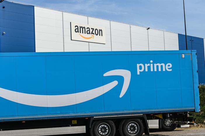 An Amazon delivery truck is parked outside a warehouse in France on April 16. The online retail giant's revenues and profits soared in the second quarter.