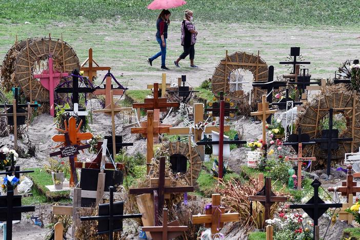 Relatives of those who have died from COVID-19 visit graves in the special area of the Municipal Pantheon of Valle de Chalco, Mexico. The coronavirus has taken a heavy toll on the country, especially its poorest citizens.
