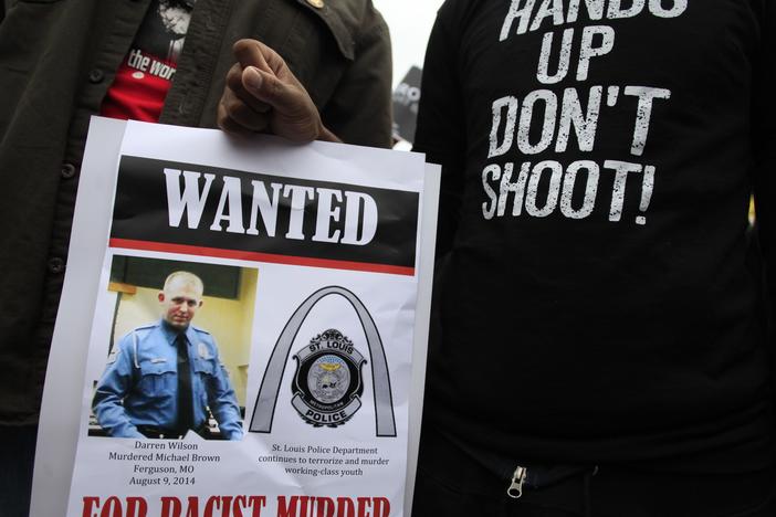 Demonstrators hold a sign in St. Louis, Mo., following the 2014 shooting death of 18-year-old Michael Brown.
