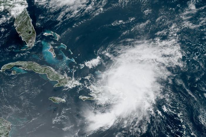 A satellite image from Thursday morning shows Tropical Storm Isaias looming over Puerto Rico and the Dominican Republic. The storm is predicted to drench Florida's east coast over the weekend.