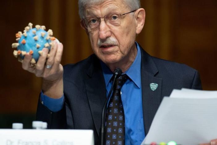 Director of the National Institutes of Health, Dr. Francis Collins, holds a model of the coronavirus. This is the sixth vaccine candidate to join Operation Warp Speed's portfolio, and the largest vaccine deal to date.