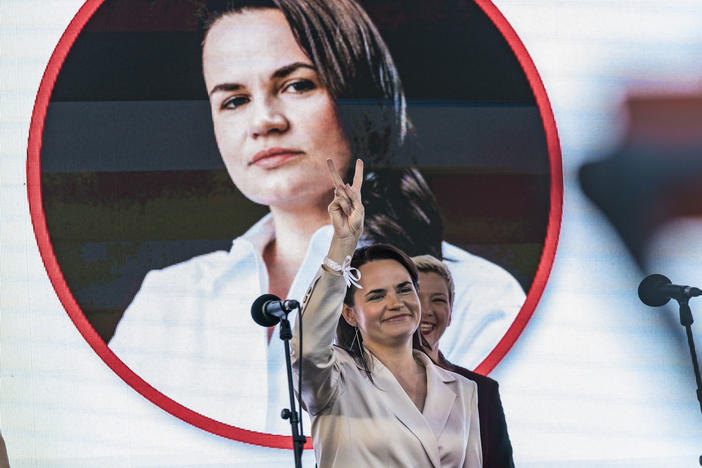 Svetlana Tikhanovskaya, presidential candidate in Belarus elections 2020, makes the symbol of victory in a rally in Minsk.