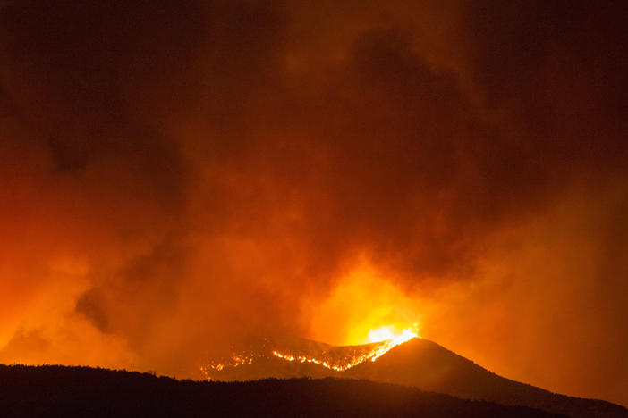 A brush fire burns amid the Apple Fire in Banning, Calif. on Saturday.