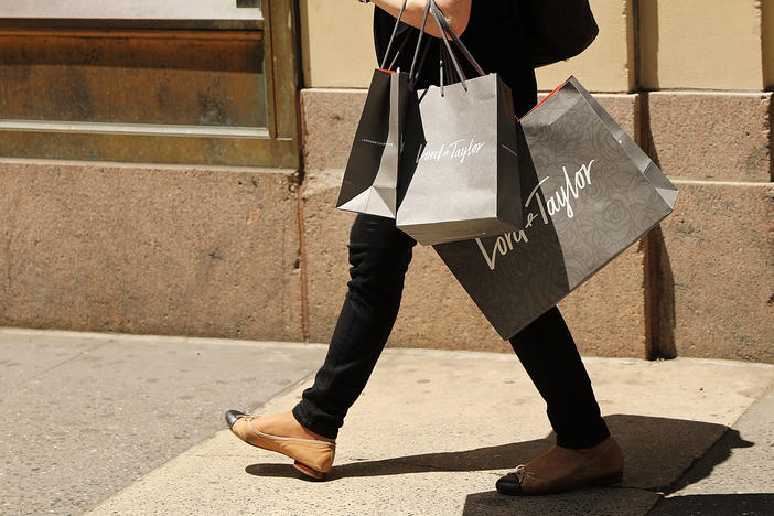 A woman walks out of Lord & Taylor's flagship store in Manhattan in June 2018, before the location was closed and the building was sold in 2019.