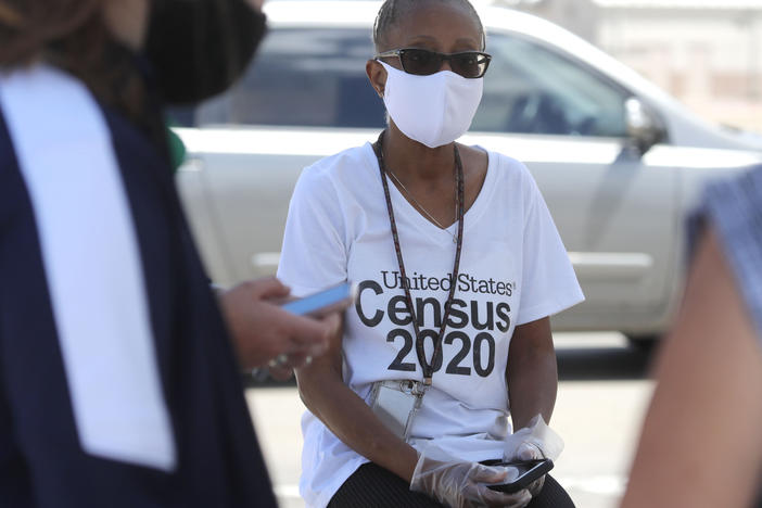 U.S. Census Bureau worker Jennifer Pope wears a face covering at a walk-up counting site in Greenville, Texas, on July 31. The bureau is ending all counting efforts for the 2020 census on Sept. 30, a month sooner than previously announced, the bureau's director confirmed Monday.