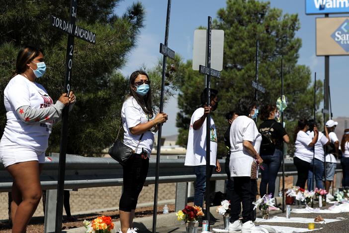 Mourners hold 23 crosses Monday in front of a Walmart honoring those killed in the 2019 attack in El Paso, Texas.