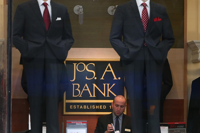 An employee works inside a Jos. A. Bank retail store in San Francisco. The parent company Tailored Brands earlier said it would close up to 500 stores and cut 20% of corporate jobs.