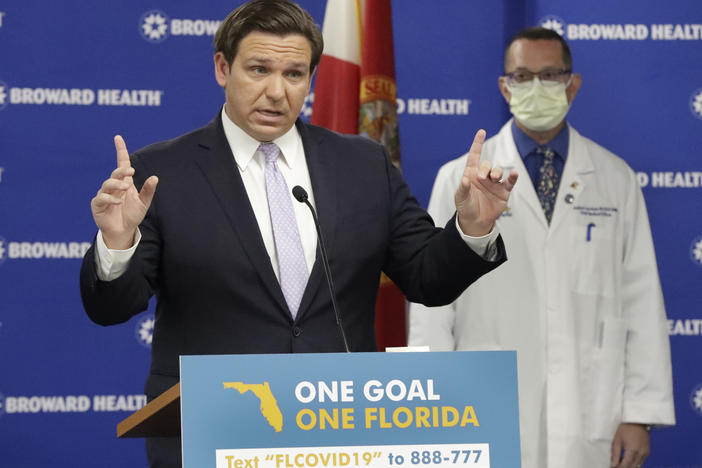 Florida Gov. Ron DeSantis speaks during a news conference Monday along with Dr. Joshua Lenchus, chief medical officer of Broward Health Medical Center. DeSantis says he's exploring ways to open nursing homes for family member visits.