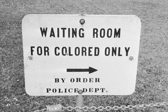 In her new book, <em>Caste, </em>Pulitzer Prize-winning journalist Isabel Wilkerson examines the laws and practices that created what she describes as a bipolar, Black and white caste system in the United States. Above, a sign in Jackson, Miss., in May 1961.