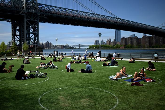 A new study has found that parks in low-income and majority-nonwhite communities are smaller and serve a larger number of people per park acre. People are seen here relaxing in May in Brooklyn's Domino Park.