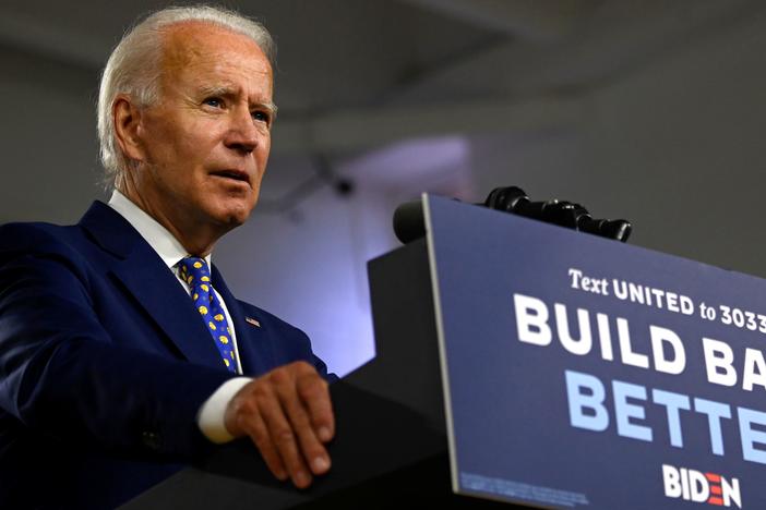 Presumptive Democratic nominee Joe Biden, seen here at a campaign event in July, says he won't tear down the border wall put in place during the Trump administration.