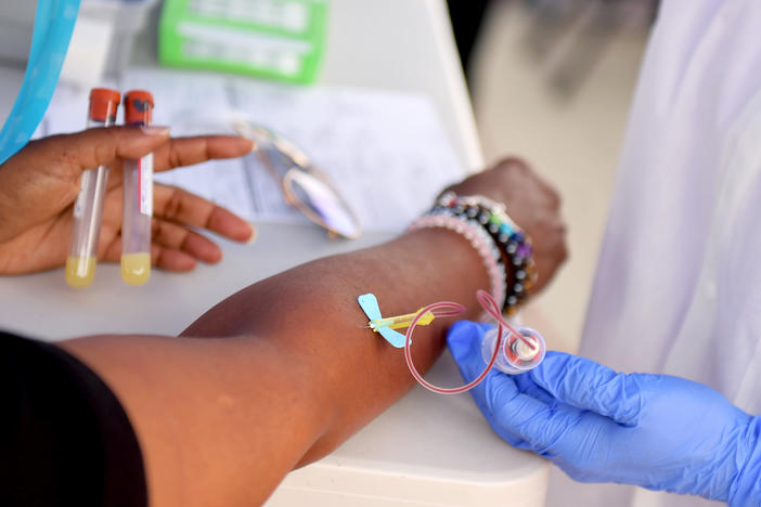 A medical worker draws blood at a free coronavirus antibody testing event in Los Angeles on Wednesday.