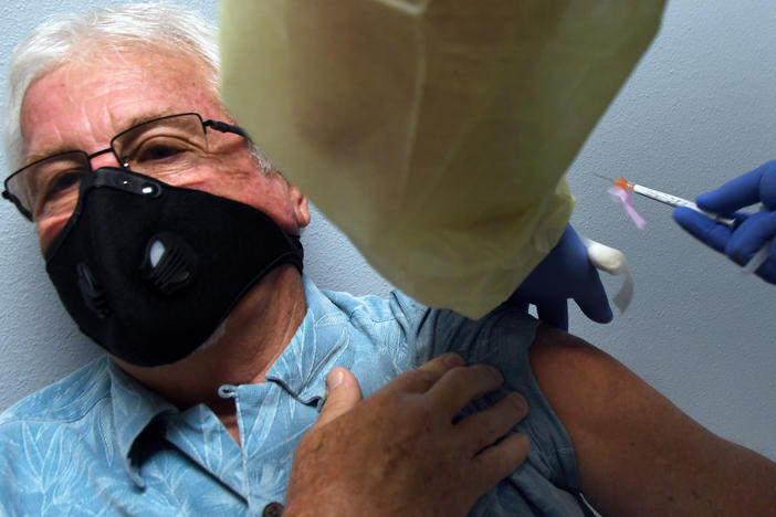 Tony Potts, 69, a retiree from Ormond Beach, Fla., receives his first Moderna COVID-19 vaccine shot Tuesday as part of the company's phase three clinical trial.