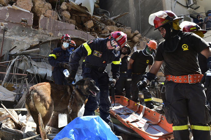 Search and rescue workers sift through damaged buildings Thursday in Beirut after this week's huge explosion at the Lebanese capital's port caused widespread damage.
