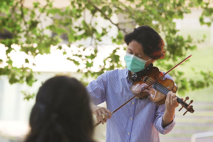 New York Philharmonic first violinist Kuan Cheng Lu, playing for a socially distanced audience of two at Lincoln Center on July 31.