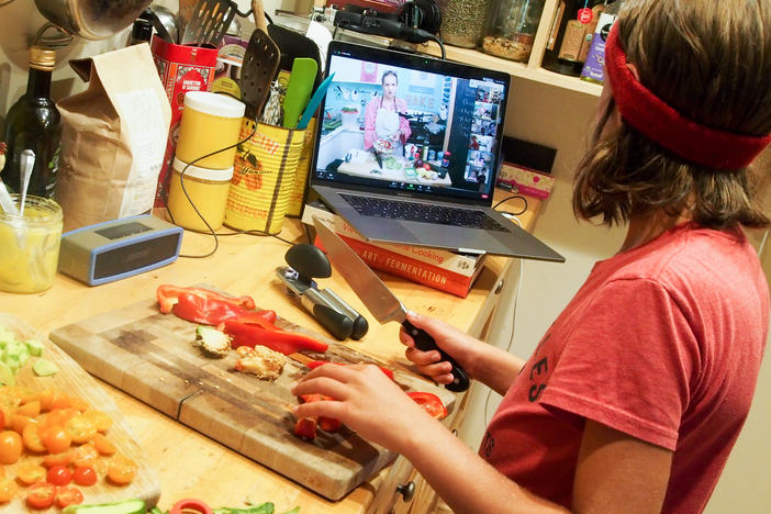 Wiley James, 10, prepares a meal as part of an online cooking camp run by a chef in Austin, Texas.