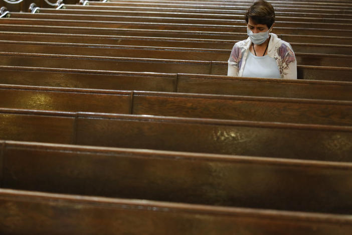 A parishioner sits after Mass last month at a Catholic church in New York City. An overwhelming majority of U.S. adults believe that houses of worship should be subject to the same restrictions on public gatherings that apply to other institutions.