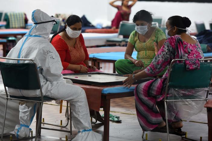 Coronavirus patients play a game of carrom inside the COVID-19 Care Centre at CWG Village Sports Complex in New Delhi on Thursday.