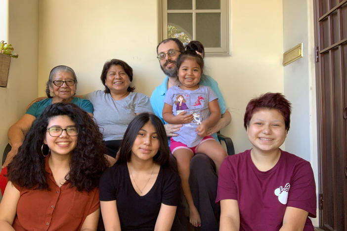 Maria Hernandez (top row, second from left) and her extended family live together in Los Angeles. When she was diagnosed with the coronavirus, she self-isolated in an upstairs bedroom.