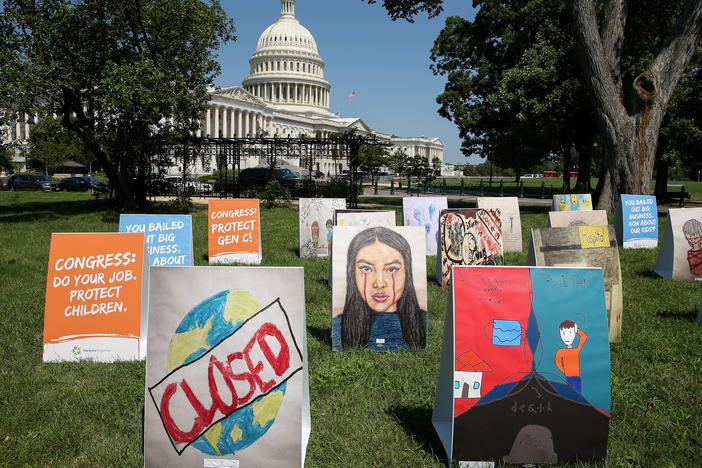 An installation of children's art is set up outside the Capitol on Wednesday. Kids can develop "severe" symptoms from the coronavirus, the Centers for Disease Control and Prevention said in a report released Friday.