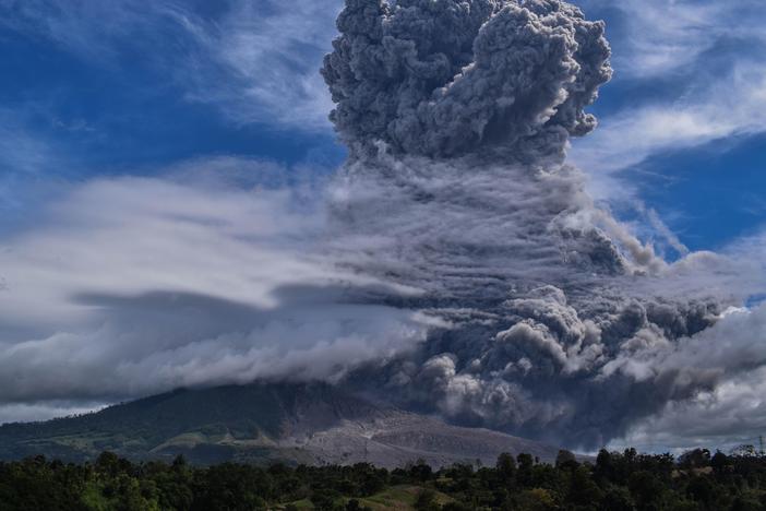 Mount Sinabung on Indonesia's Sumatra Island spews thick ash and smoke miles into the sky on Monday.