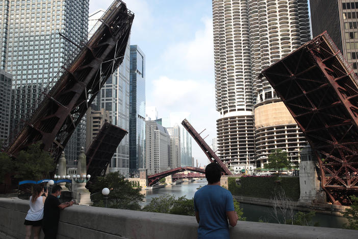 Bridges that lead into downtown Chicago were raised to limit access after looting and vandalism late Sunday and early Monday. Police made more than 100 arrests during the night of unrest and confiscated five guns.