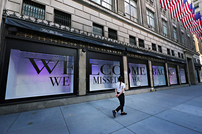 A pedestrian walks by Saks Fifth Avenue as New York City continues relaxing more restrictions imposed to curb the coronavirus pandemic.