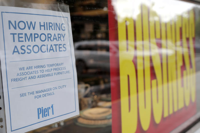A sign advertises hiring of temporary workers at a Pier 1 store that's going out of business in Coral Gables, Fla. Last week, initial unemployment claims broke a 20-week streak of being above 1 million.