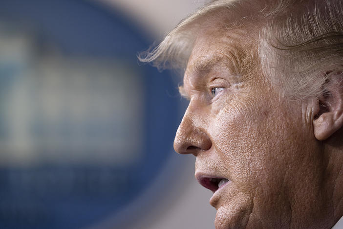 President Trump speaks at a White House briefing Thursday. Earlier he told the Fox Business Network that he plans to block additional funding and election assistance for the U.S. Postal Service to prevent efforts to expand mail-in voting.