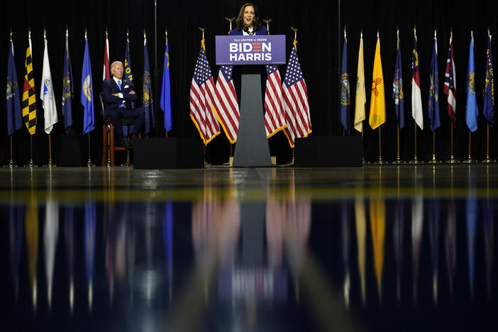 Presumptive Democratic presidential nominee and former Vice President Joe Biden listens as his running mate Sen. Kamala Harris, D-Calif., speaks during a campaign event at Alexis Dupont High School in Wilmington, Del.