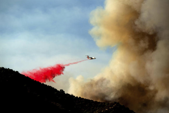 An air tanker drops retardant as the Lake Fire burns in the Angeles National Forest north of Santa Clarita, Calif., on Thursday.