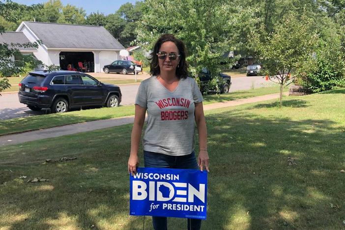 Instead of attending the Democratic National Convention in person, Bobbi Green is volunteering and handing out Joe Biden yard signs in Eau Claire, Wis.