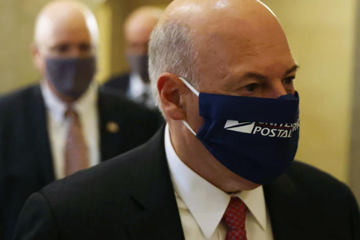 Postmaster General Louis DeJoy is under fire for management changes he has made to the Postal Service that some say could slow the delivery of absentee ballots this fall.