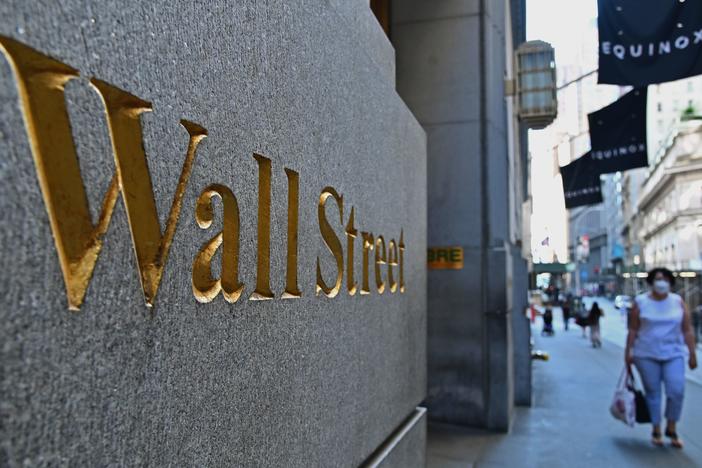 People walk near the New York Stock Exchange in June. The S&P 500 index has fully recovered from its plunge earlier this year when the pandemic began shutting down much of the economy.