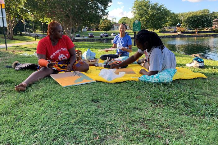 From left to right, Aijah Crockett and Lisa Griffin join their friend visiting from New York, Dom Carter, at Jack D. Hughes Memorial Park in Pineville, N.C. Crockett and Griffin are both Charlotte area residents who are voting for Democrat Joe Biden.