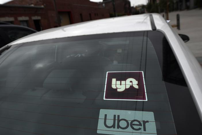 An appeals court has given Uber and Lyft more time to fight a judge's order over how they classify their drivers, averting a threatened shutdown in California.