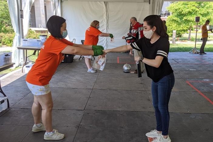 University of Illinois graduate student Kristen Muñoz submits her saliva sample for coronavirus testing on the Urbana-Champaign campus.