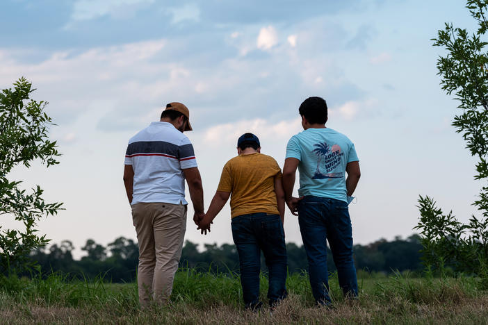 Honduran migrants, Ricardo Sr., (left), his son Ricardo Jr., 13, and his cousin Jorge, 16, walk near their home in Texas. When the two teenage boys crossed the border illegally into Texas last month, they turned themselves in to the Border Patrol. They were later escorted to a hotel by armed men in civilian clothes.