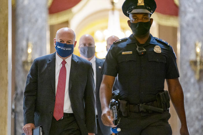 Postmaster General Louis DeJoy, left, visits Capitol Hill earlier this month. DeJoy is set to testify before Senate and House panels in the coming days over his controversial plans to cut costs at the U.S. Postal Service. Many Democrats fear these changes could slow the delivery of mail ballots this fall.