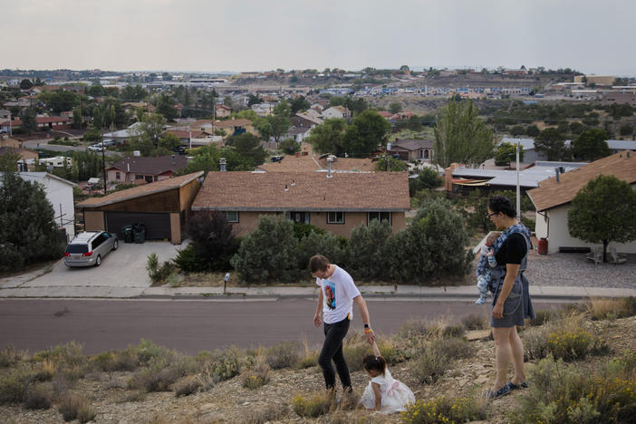 Dr. Chris Hoover (left) and Dr. Connie Liu (right) walk through their home with their children Taro, 3, and Hiro, 4 months, in Gallup, N.M. On a short reporting trip across the Southwest, NPR met very different families and asked them the same simple question: What's been keeping you at night?